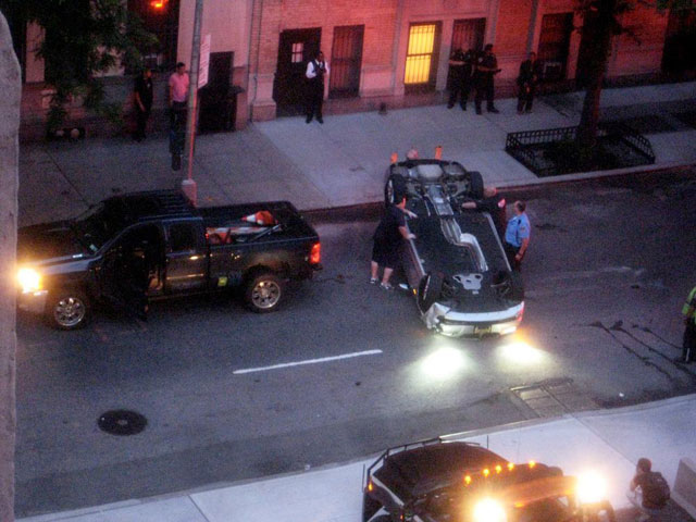 A car upside down in the middle of W 45th St