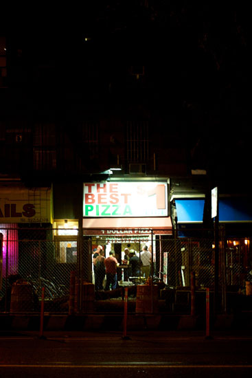 Several people in the $1 pizza store late at night