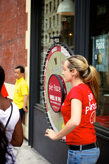Pie Face staff with a prize wheel promotion set up