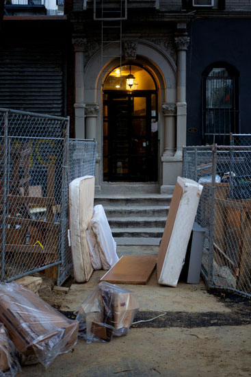 Mattresses forming a corridor on the sidewalk