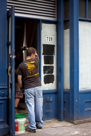 Workers carrying a drywall sheet into the under-construction Pie Face
