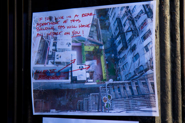 A printout of an aerial image of Clubhouse BBQ's outdoor area with warnings written on it