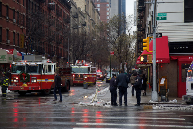 Several fire engines waiting nearby